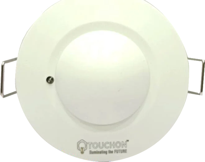 A round white recessed sensor with sprung mounting clips folded out on either side of its body