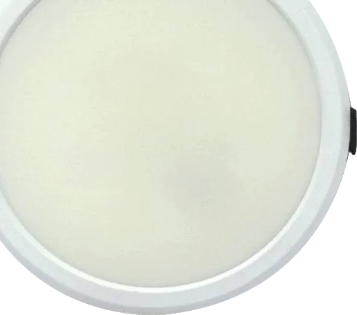 A round white recessed panel light with a softly glowing opal diffuser filling its face