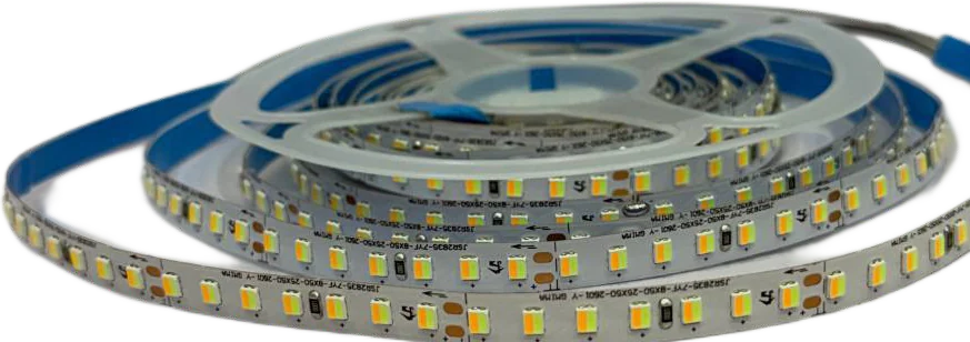 A large reel of tunable-white LED tape, the unwound length showing alternating warm and cool chips side by side